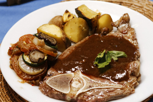 T-Bone steak with a side of ratatouille and baked potato Brown sauce:  For the stock: cow bones boiled for 6 hours until the soup becomes a thick sludge-like consistency.  Fry some flour on a hot pan until slightly brown mix with stock, add rosemary,