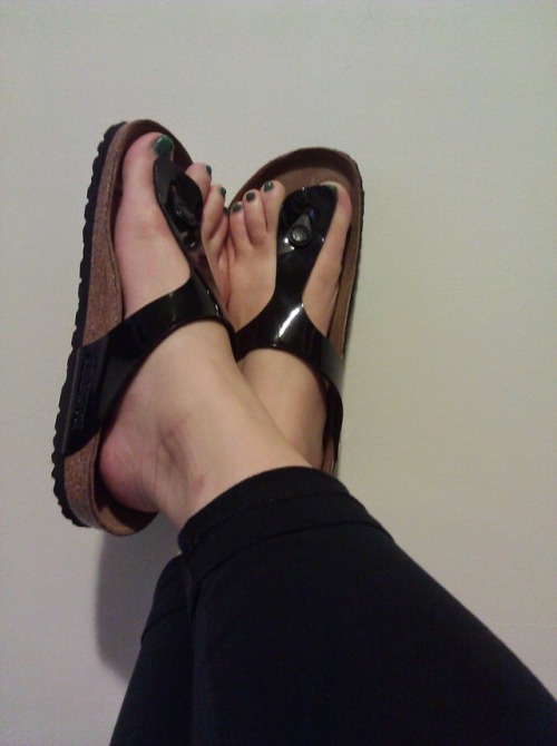 Black thong Birkenstocks on pretty feet.