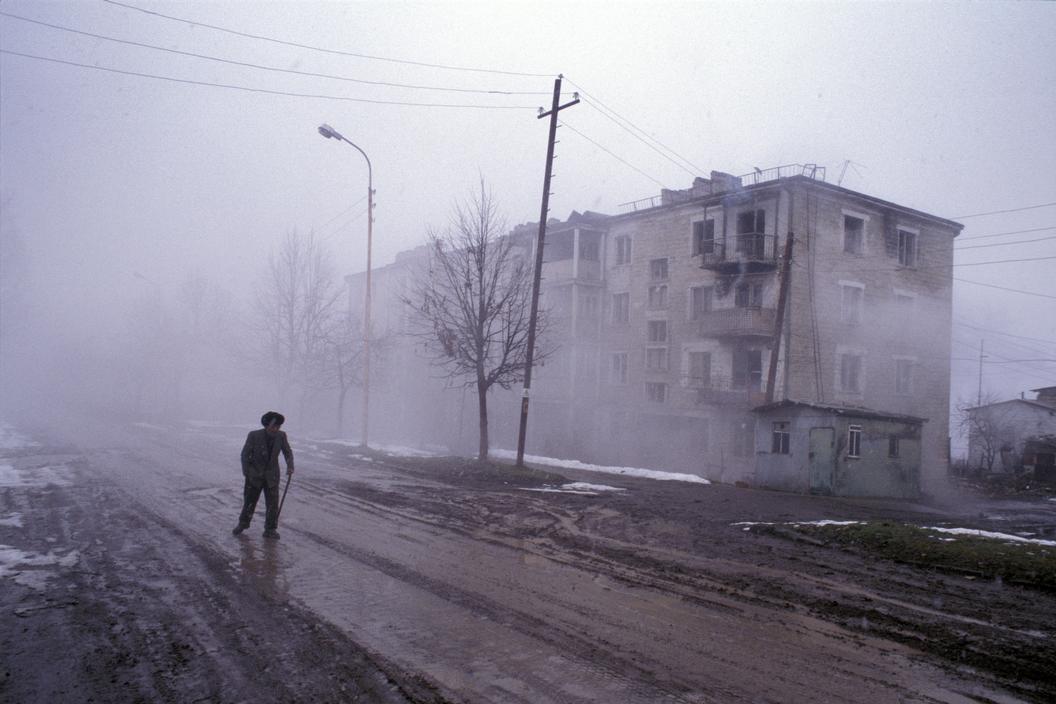 hogpig:  Nagorno Karabakh. 2005. A man walks past the half-empty apartment blocks