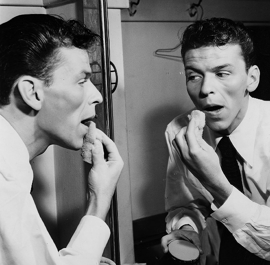 francisalbertsinatra: Frank Sinatra applying pancake makeup in his dressing room,