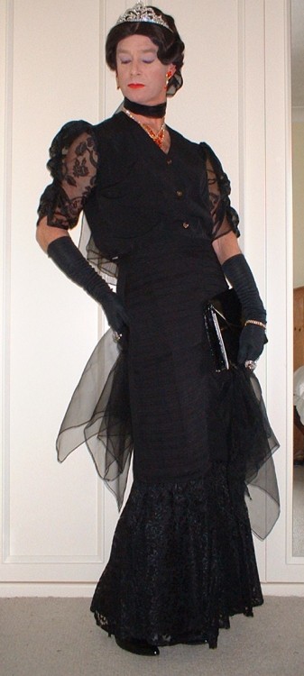 Long flounced evening skirt with chiffon sleeved blouse, chiffon scarves and wrap, patent black clut