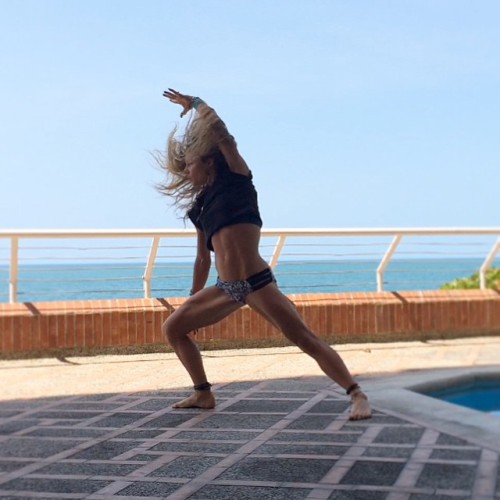 Poolside #yoga- Hair flipping into Warrior-time. #vinyasa #Hypsygypsy #warriorpose #hairflip (at Edi