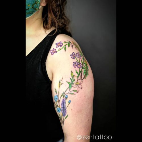 Added some cute little #violets #lily and #pine to her arm #flowers #floral #tattoo #girlswithtatto