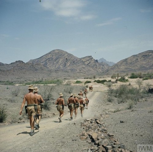 A company of the Royal Sussex Regiment march along a track in theRadfan mountains (Aden Protectorate