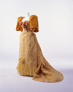 lost-in-centuries-long-gone:Ball Gownc. 1894Designer: Charles-Frederick WorthBrand: WorthLabel: PARIS C. WORTH PARISMaterial: Yellow silk brocade with tassel pattern; two-piece dress with gigot sleeves; silk taffeta bow at breast; silk chiffon decoration