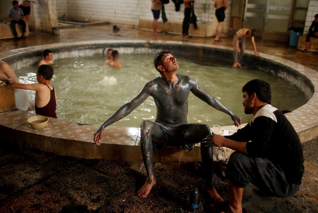 Irak reabre sus baños de barro, un spa en medio del caos de guerra Mosul. Una cubierta iraquí a su hijo con arena de un estanque de azufre en la ciudad de Hammam al-Alil al sur de Mosul, Irak 3 de abril de 2017. Algunos iraquíes se hacen un masaje en...