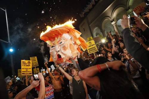 shitheadgod:  Thousands rail against Trump: Protesters march on 101 Freeway in L.A., burn Trump’s head in effigy(photos by Marcus Yam)