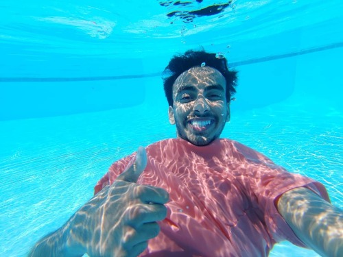 Underwater clothed barefaced guy