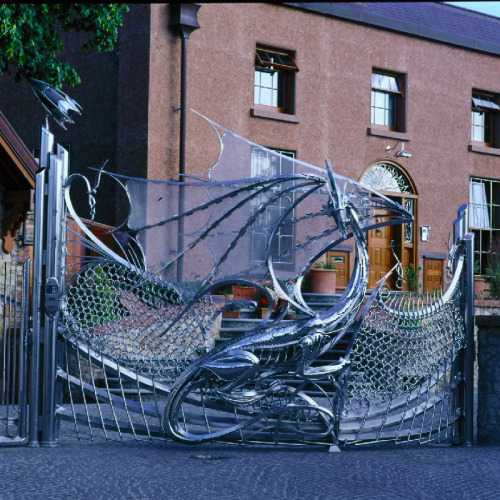hideback:  Dragon’s Gate, Harlech House Goatstown, Dublin, Ireland. Curved Stainless Steel with Glass Eyes. Started circa 1993. Harlech House is a 7-bedroom estate built in 1798. Incredibly elaborate steel ornaments adorn the entire property, including