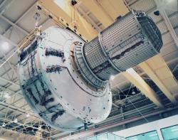 gunsandposes-history:  The airlock for the International Space Station is lifted by crane during manufacturing in the Space Station Manufacturing Building at the Marshall Space Flight Center in Huntsville, Alabama, December 10, 1997. (NASA)