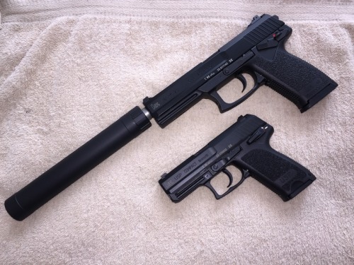 coffeeandspentbrass: Here we see the adult MK 23 with its offspring the USP Compact. The MK 23 will 