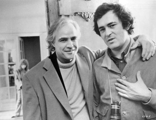 Marlon Brando and director Bernardo Bertolucci on the set of Last Tango in Paris. In the background,