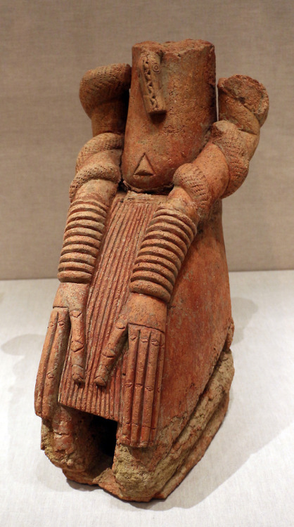 Sculpture from the medieval town of Djenné, in present-day Mali, showing a seated figure with serpen