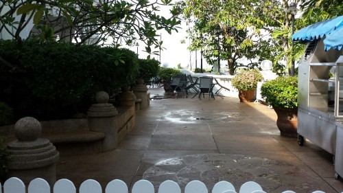 The poolside area, the entrance to a buffet restaurant, and a nearby hallway including some rooms (o