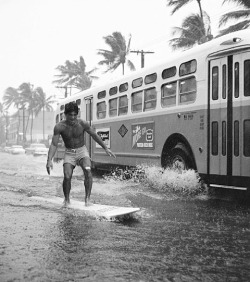 losetheboyfriend:Rainstorm street surfer, Waikiki, Honolulu; captured by Warren Roll (1960)