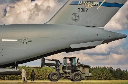 Airmen offload cargo from a Mississippi Air National Guard C-17 Globemaster III on the flightline at