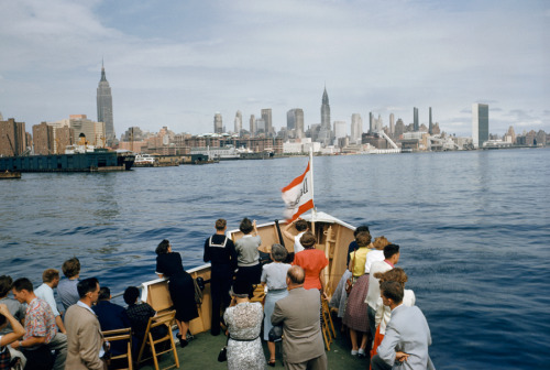 Tourists look at Manhattan from a sightseeing boat on the East River, December 1954.Photograph by Ro