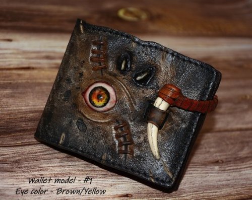 sixpenceee:A zombie eye, steampunk leather wallet. The wallet is handmade in a vintage style with genuine leather, with realistic, distressed detailing and durable material