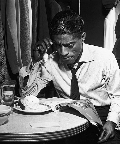 American dancer, singer and actor Sammy Davis Jr eats pound cake a la mode in his dressing room, 4th November 1953.  
