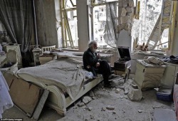 sixpenceee:A Syrian man has a moment of peace amid a war ridden room.