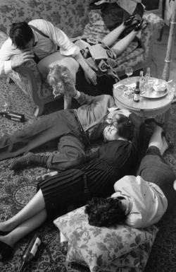 vintageeveryday:A group of people lying in a drunken heap in a living room, 1954. Photographed by Kurt Hutton.