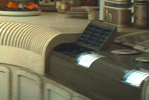 I Love The Design Of Eedy's Kitchen With Its Tiny Cramped Dining Area, Dim Lighting, Yellowed Walls,