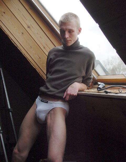 mostlymensunderwear: Posing in the window in his bulging briefs