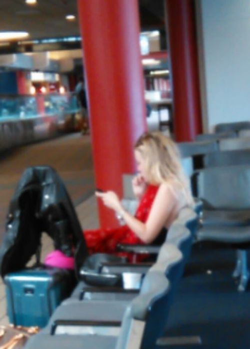 Blurry photo of Dakota Fanning at Pittsburgh International Airport on September 19, 2015. Dakota is 