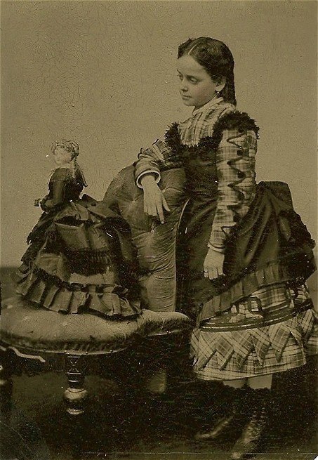 marzipanandminutiae:a-bygone-era:A Girl & her Dollearly 1870s. the doll is a French fashion doll