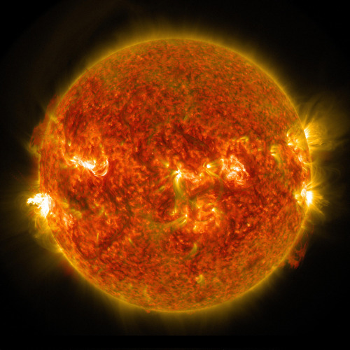 The sun emits an M5 flare, seen on the left, August 24, 2014 js