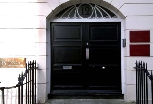 Black door with window above like bats wings.