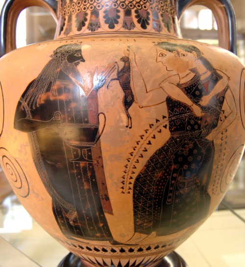 Dionysus faces two Maenads, one of whom holds a hare.  Side B of an Attic black-figure neck-amphora,