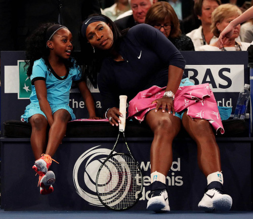 soph-okonedo:Serena Williams speaks to a young fan on the bench as she plays Caroline Wozniacki duri