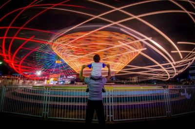 natgeotravel:
“Lights zip by visitors at a carnival in Japan.
Photograph by Danilo Dungo, Your Shot
”