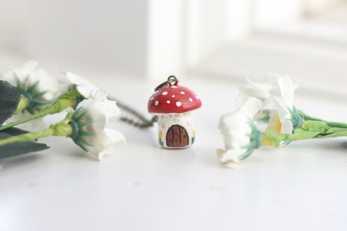 ash-elizabeth-art: This necklace features a mushroom fairy house with a little door and some flowers