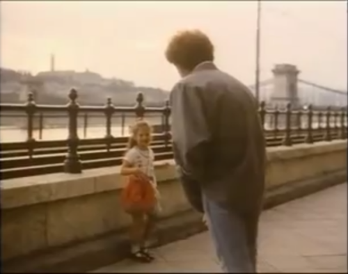 John Deacon talks to a young girl in Budapest, Hungary (1986)Girl: [says something unintelligible]De