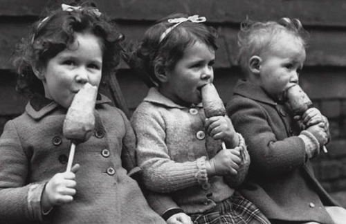  Children eating carrots on a stick during the 1940s when rationing was fully implemented 