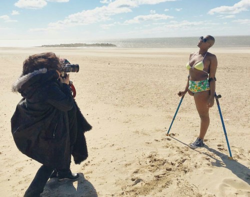 interdevo: Mama Cax is posing in bikini and converse shoe, standing on crutches on cold winter beach