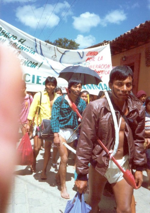 Native men wearing loincloths and carrying bows and arrows marching on October 12, 1992 in Mexico, 5