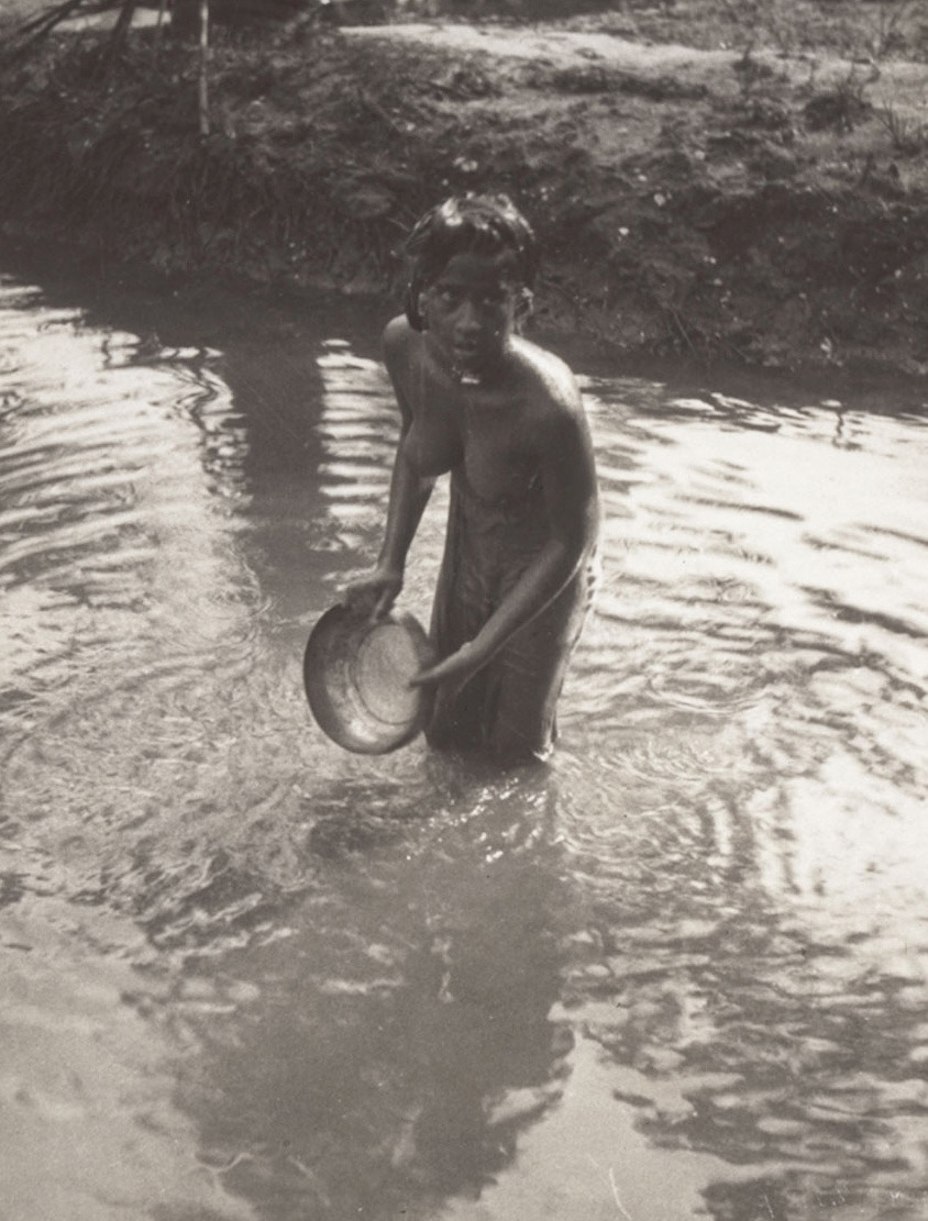 A theeyya lady taking a daybath in the stream Via Kalli Valli.