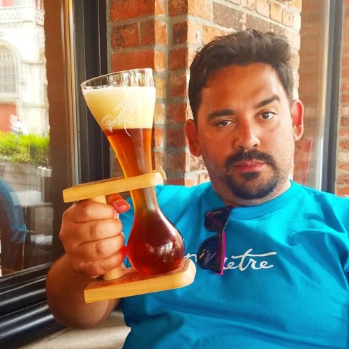 My husband holding up an unusual beer presentation in Bruges, Belgium