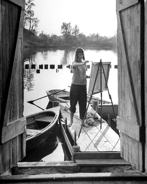 life:A young woman standing on a dock painting at the Saugatuck Summer Art School in Connecticut dur