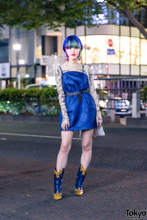 Japanese street style personality Rikarin on the street in Harajuku wearing an X-Girl dress over an 