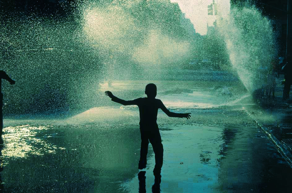 24kblk:thomas hoepker, children cool off with open fire hydrants on a hot july weekend.