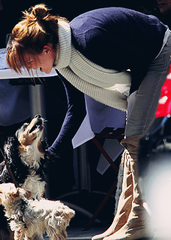 fiftyshadesen:  Emma Watson gives a scratch to a passing dog as she enjoys lunch