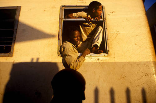 mvtionl3ss:  Men hanging out of the window on the train between Djibouti and Addis Ababa. Photo by M