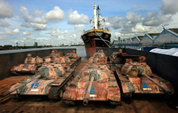 gunrunnerhell:  Tanked Thai officials push over a T69-2 Chinese made tank into the sea at Narathiwat province, southern Thailand, 09 August 2010. The Thai military dropped 25 T69-2 tanks purchased from China in 1987 into the Gulf of Thailand to serve