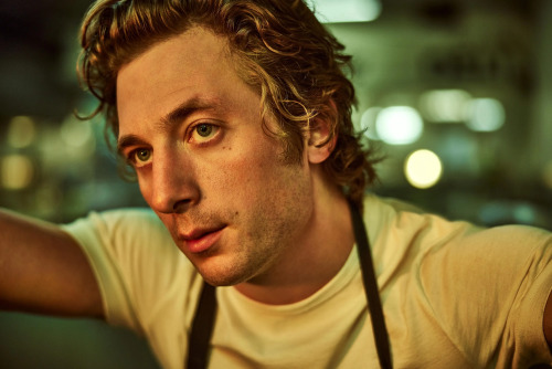 carmen berzatto (jeremy allen white) from the bear on hulu, a close up while he's leaning into an open space, eyes fixated slightly to the side looking at something off screen.