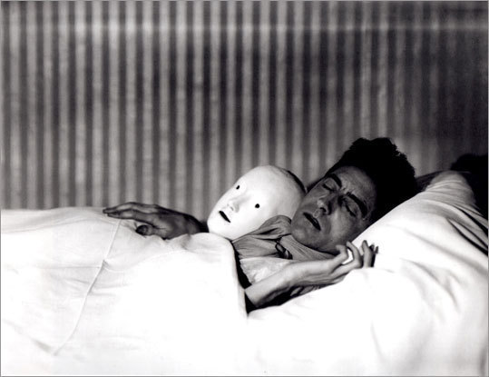 maudelynn:  “Cocteau in Bed with Mask.” by Berenice Abbott 