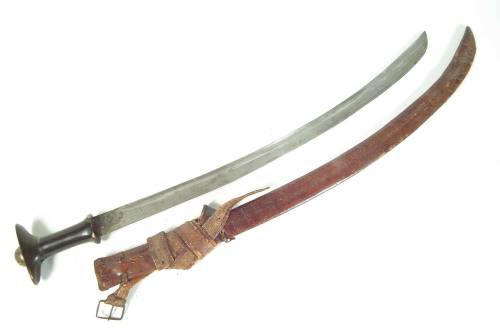 Ethiopian GuradeWith horn grip topped with brass pommel, tooled leather scabbard. 106 cm long.